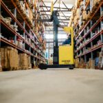 Forklift in a warehouse representing business equipment eligible for 100% bonus depreciation
