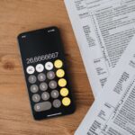 Calculator and tax forms on a desk representing the Q3 2026 estimated tax deadline